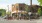 a group of people gather outside a restaurant
