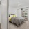 a bedroom with a bed and shelves