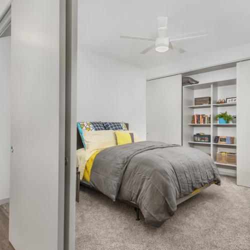 Relax and recharge in beautiful and spacious bedrooms a bedroom with a bed and shelves