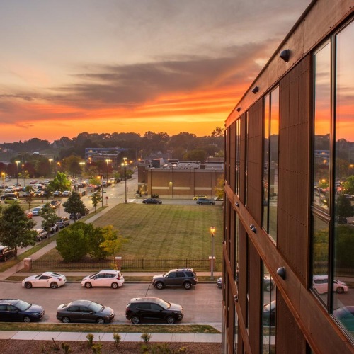 Settle into comfort at Belay Apartments a building with streets and cars outside