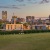 a city skyline with a large field in front of it