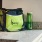 a green bag and two green bottles on a counter