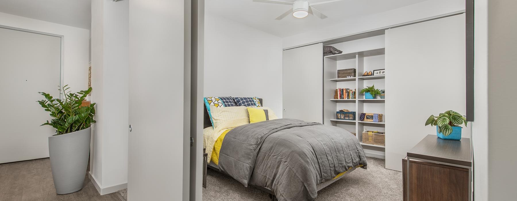 a bedroom with a bed and shelves